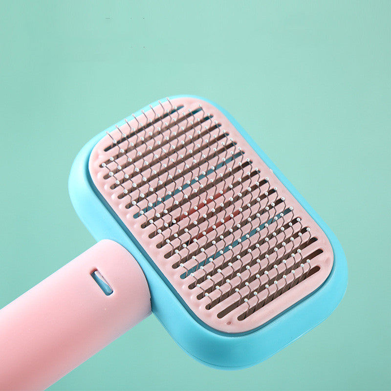 Pink pet grooming comb in use — stainless steel